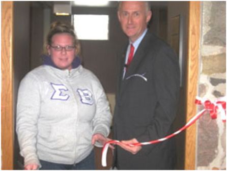 President of Sigma-Beta cuts the tape to Theater